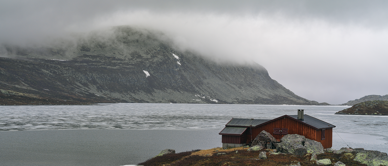 Hasselblad X1D Medium Format Sample Image of a traditional red timber nordic cabin in front of nordic ocean bay with mountain